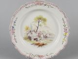 a plate with a picture of a man and a dog on it