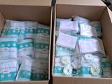 two boxes of diapers that are sitting on a table