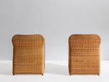 pair of wicker lounge chairs in the manner of person