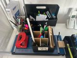 a desk with a lot of office supplies on it