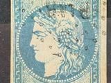 un timbre bleu sur lequel figure la tête d'une femme