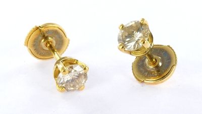 pair of diamond stud earrings on white background