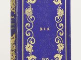 a blue book with gold writing on it sitting on a white surface