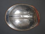 a silver plate with a handle on a table