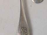 two spoons and a fork sitting on a table