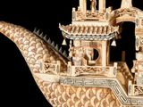 carvings of a boat with people on it on a black background