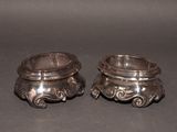 pair of antique silverplated candlestick holders on a black background