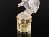 an image of a glass figurine of a woman holding a umbrella