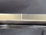 a comb on a table with a mirror in the background