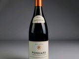 a picture of a bottle of red wine on a table