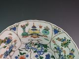 a plate with a design of flowers and birds on it