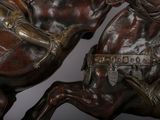 a statue of a man riding a horse with a sword