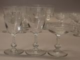 several empty wine glasses are lined up on a table