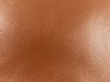 a close up view of a brown leather surface