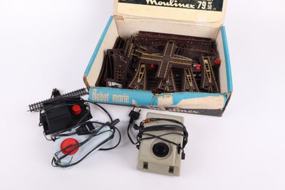 a box of miniature train tracks and a box of batteries