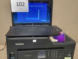 a laptop computer sitting on top of a printer