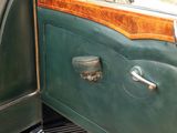 a close up of a door handle on a green car