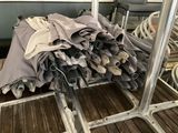 a pile of umbrellas sitting on a rack in a room