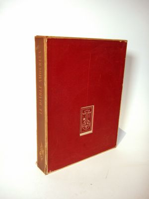 a red book that is sitting on a white surface