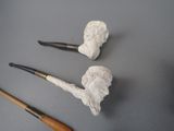 two pipe holders and a pipe holder on a table