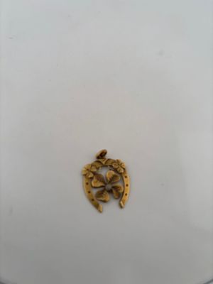 a white plate with a gold decoration on it