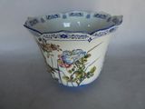 a blue and white bowl with a flower design on it
