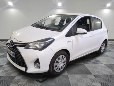 a picture of a white toyota yaris parked on a checkered floor