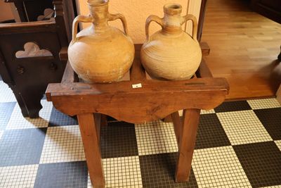 deux vases posés sur une petite table dans une pièce