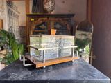 a model of a boat on a table in front of a mirror