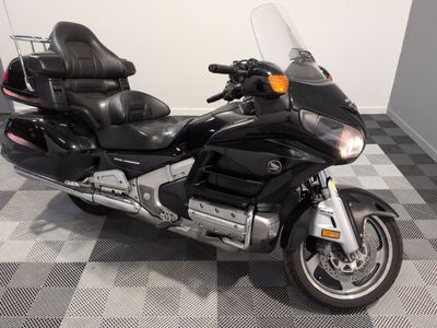 a black motorcycle that is parked on a checkered floor