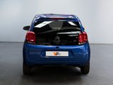 a small blue car that is parked in a room