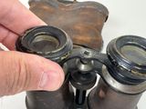 a person holding a pair of binoculars in their hand
