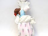 a figurine of a woman holding a baby in her arms