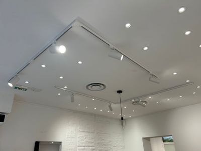 a room with a ceiling light and a white brick wall