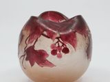 an image of a glass vase with red flowers on it