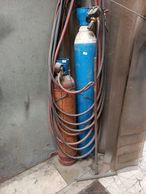 a blue fire hydrant next to a metal door