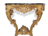 an ornately carved console table with a marble top