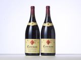 two bottles of red wine sitting on top of a table