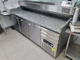 stainless steel counter top in a commercial kitchen with stainless steel appliances