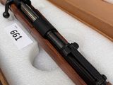 a rifle that is in a box on a table