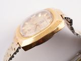 a close up of a watch on a white surface