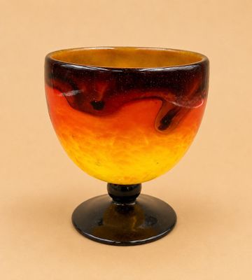 un saladier en verre orné d'un motif rouge et jaune
