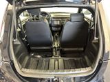 two seats in the back of a car with the trunk open