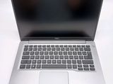 an open laptop computer sitting on top of a white table