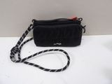 someone is holding a black purse with a white and black striped strap