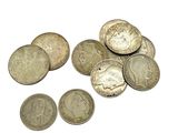 some coins are sitting on top of each other on a white surface