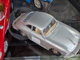 two toy cars that are on display in a glass case