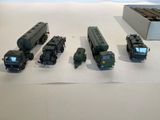several military vehicles are lined up in a row on a white surface