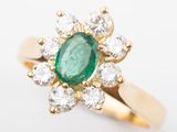an image of a green emerald and diamond ring on a white background