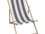 a white and black striped beach chair on a white background